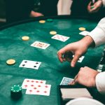 Casino scene with dealer and players, featuring cards and chips, creating a suspenseful atmosphere.